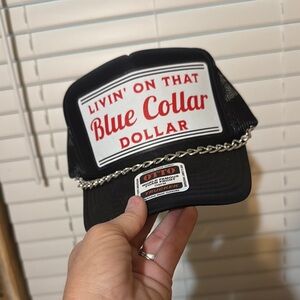 OTTO Black Trucker Hat with Red and White Design live on that blue collar dollar